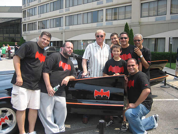Adam West signs the "Rock Star" Batmobile.